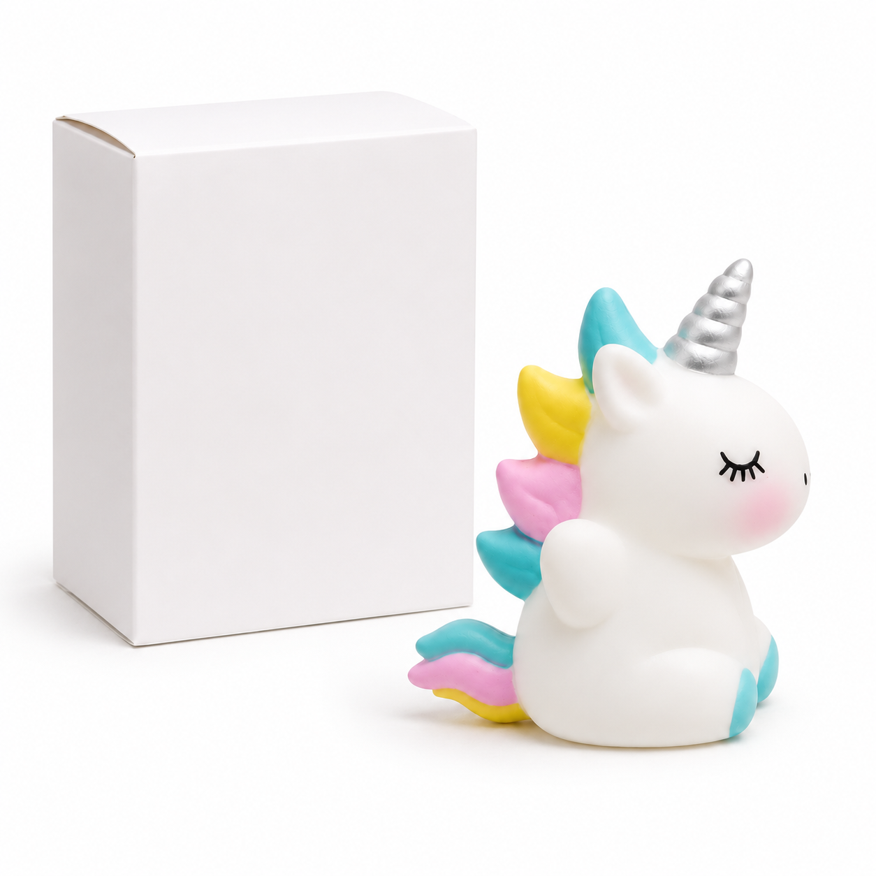 Squishy Unicorn white with rainbow mane in white packaging box with toy outside front view soft squeezy ages 3+